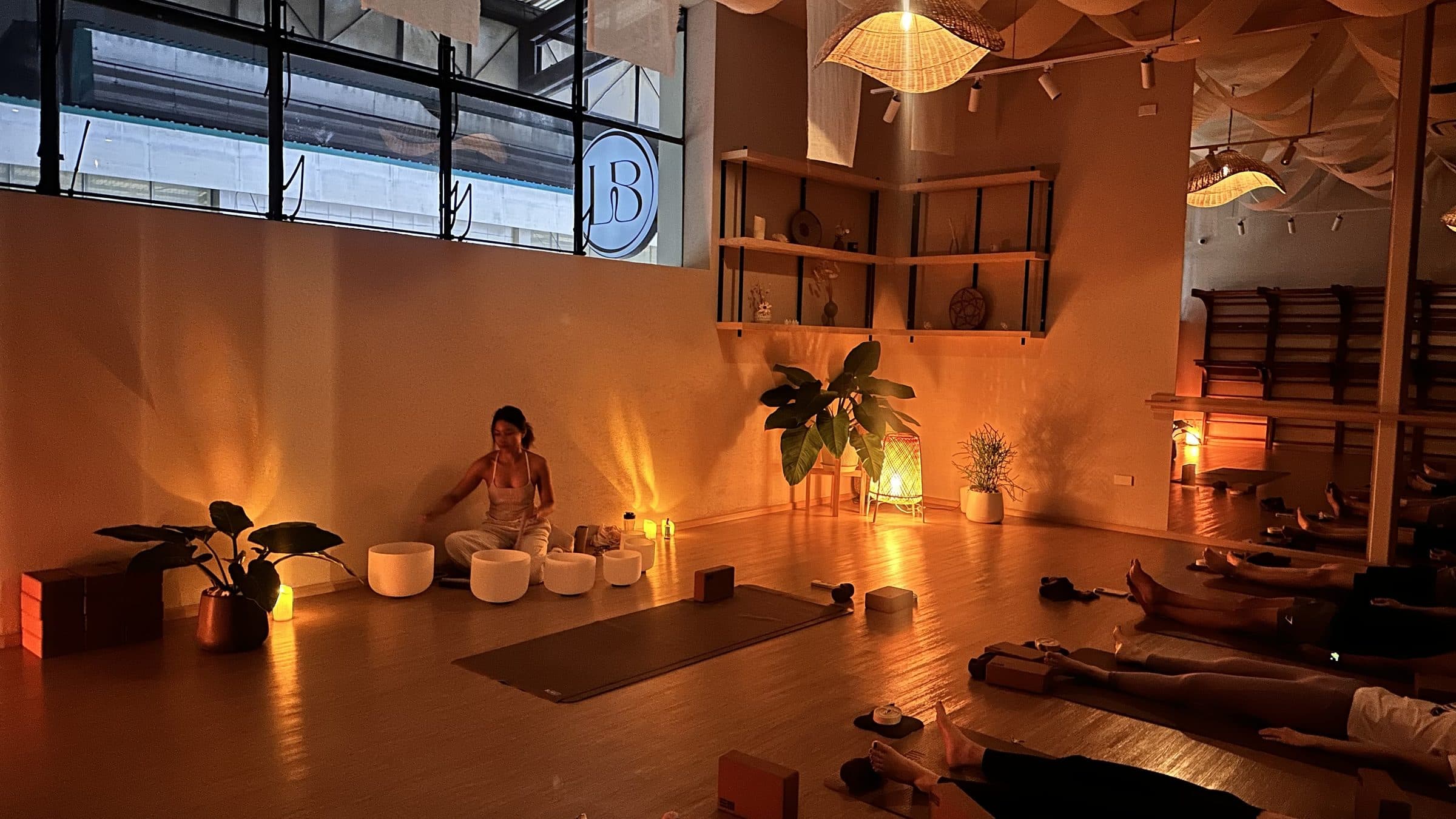 A sound bath circle in a softly lit Bangkok studio